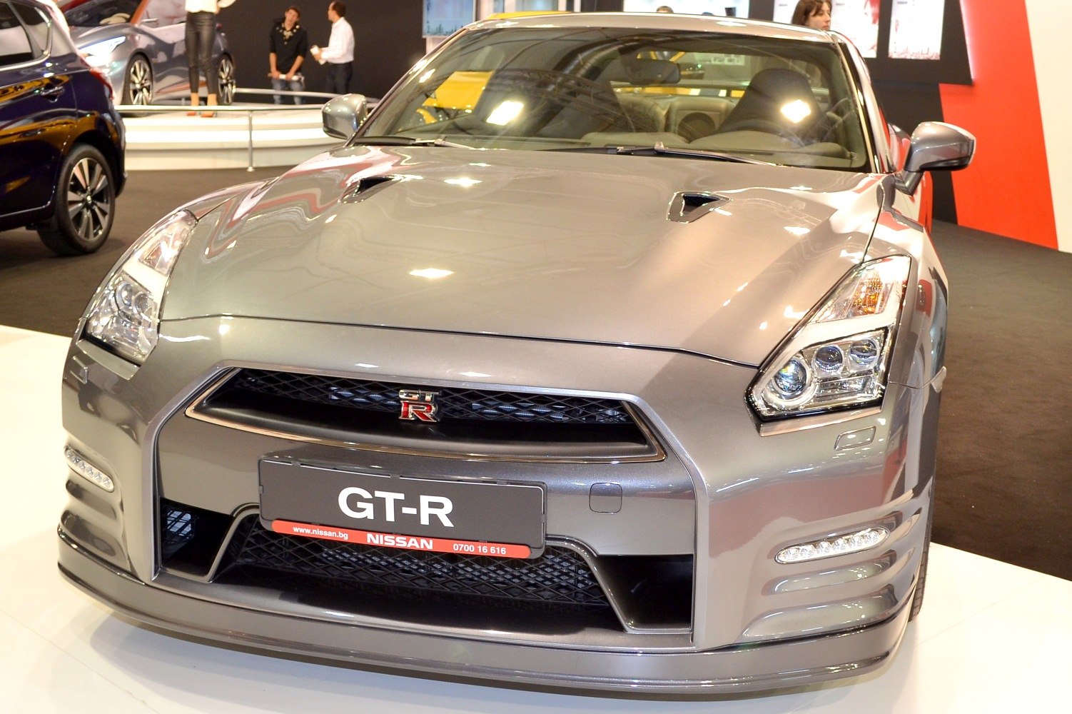 Front view of aggressive grille and headlights of a sports car.