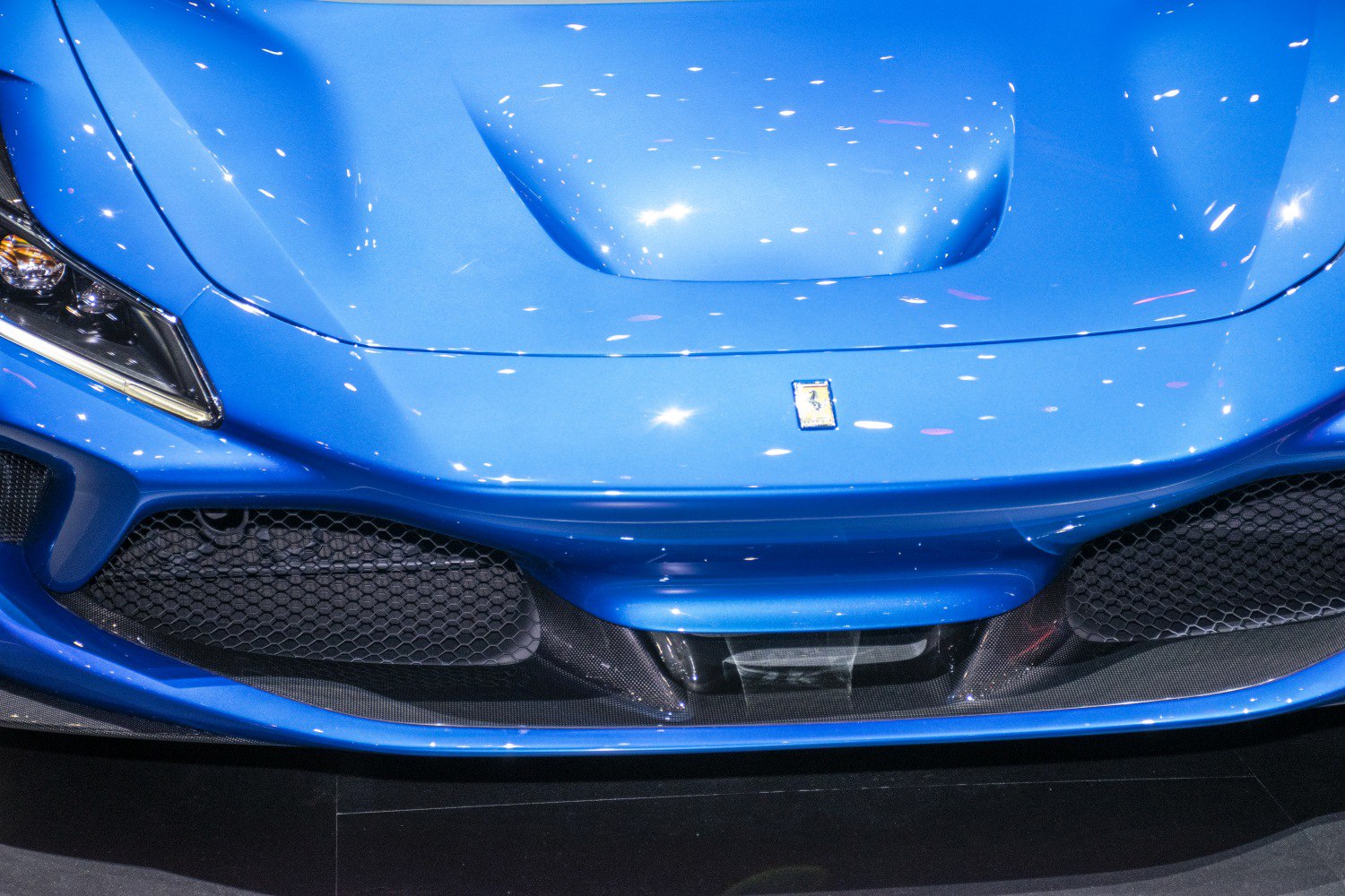 Close-up of front hood and headlight with aerodynamic grille
