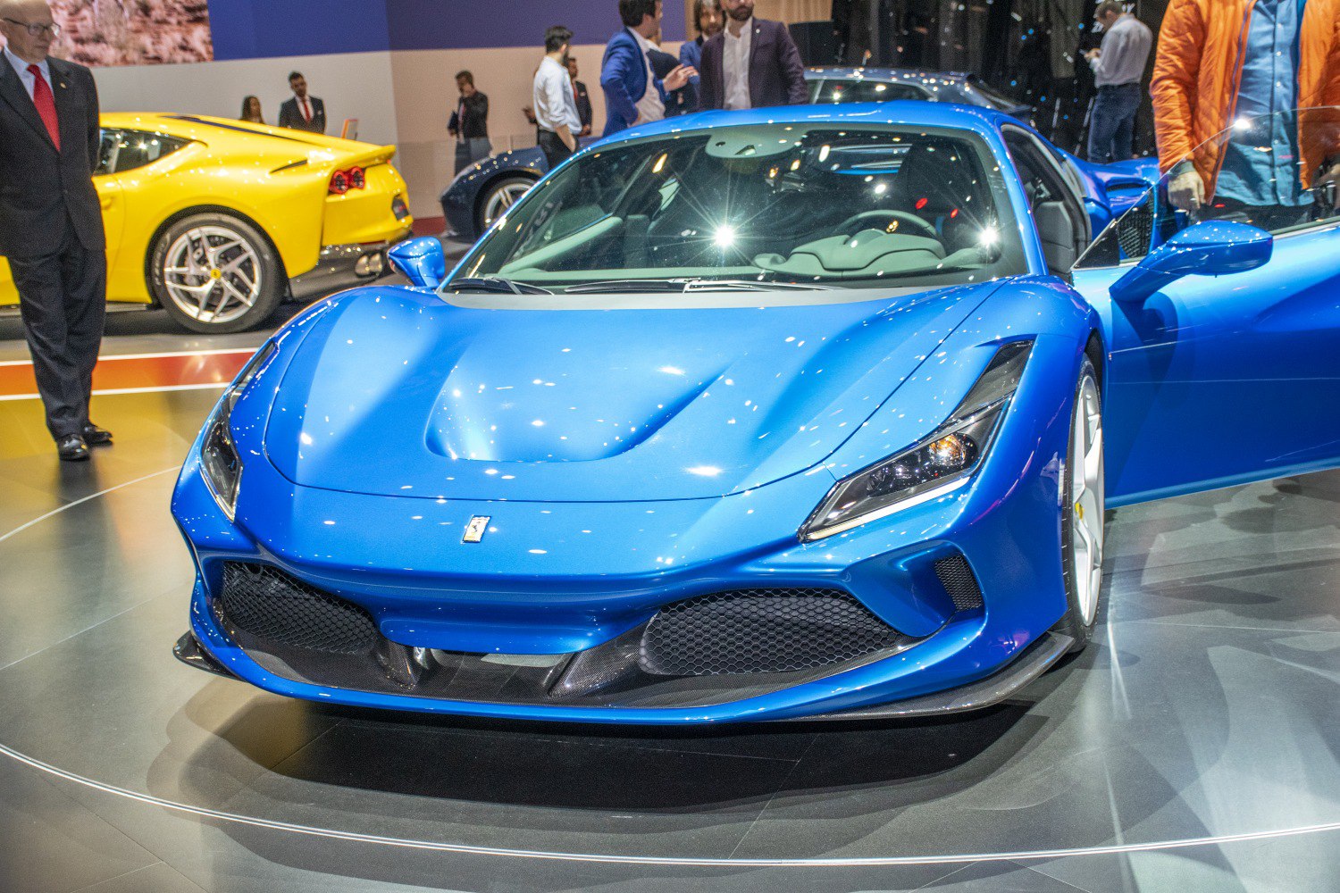Blue sports car front with sleek headlights and aerodynamic grille