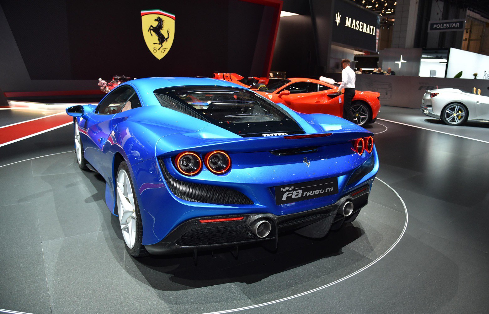 Dual round tail lights and central dual exhausts on a sleek blue rear end