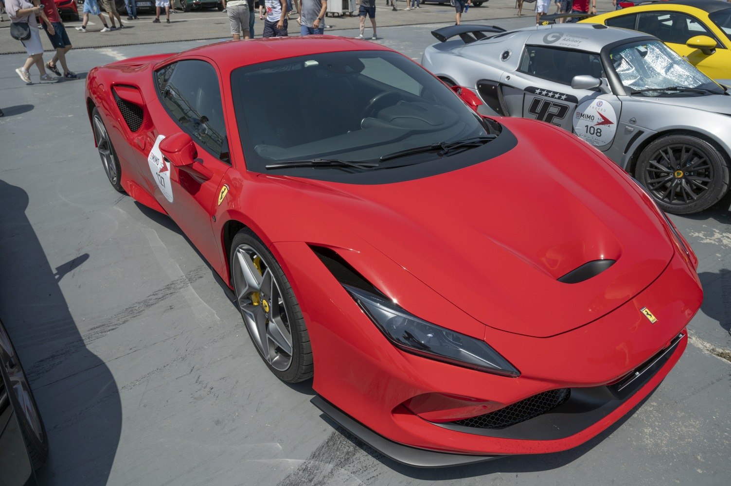 Red sports car front view with aerodynamic design and aggressive headlights