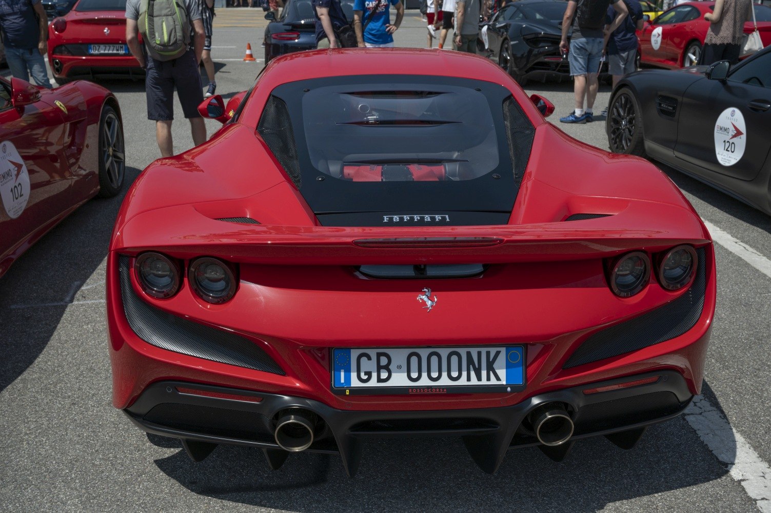 Red sports coupe rear with quad exhausts and engine window