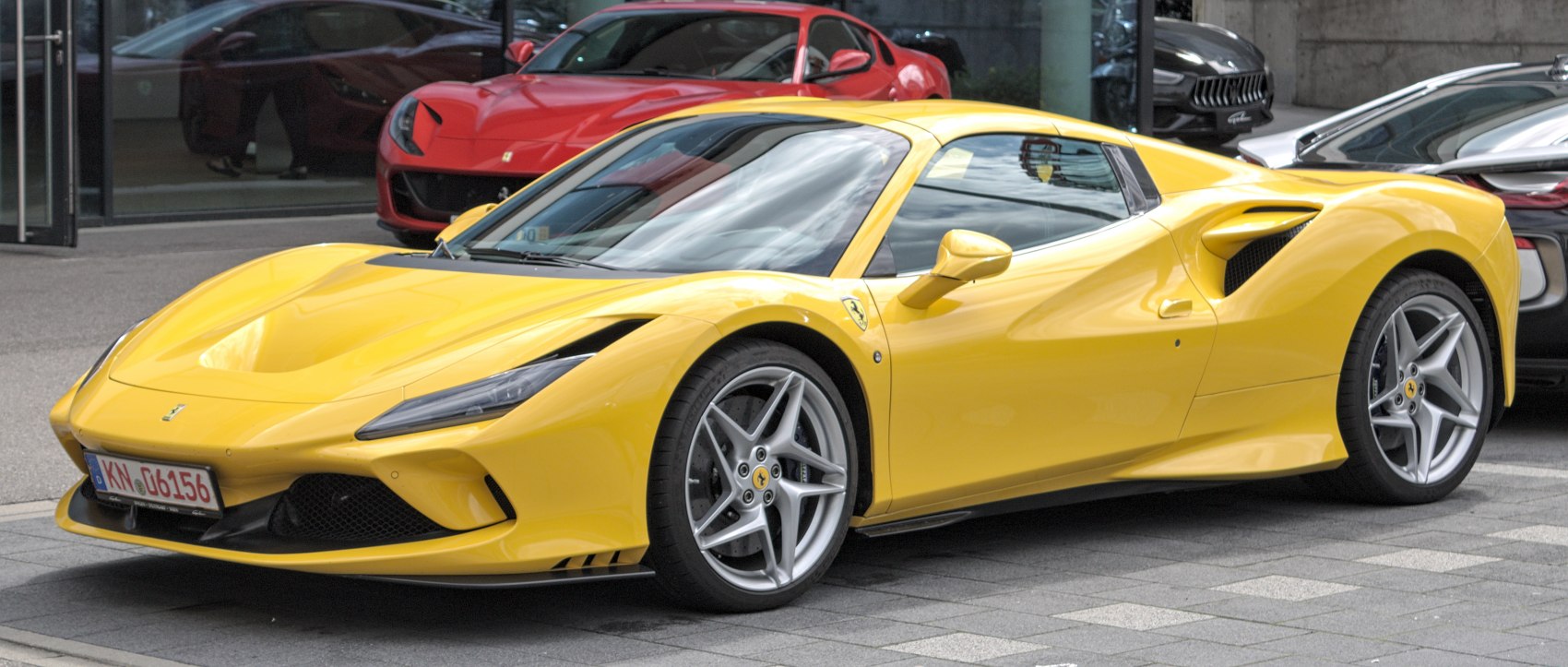 Yellow sports coupe with sharp headlights and aerodynamic side vents.