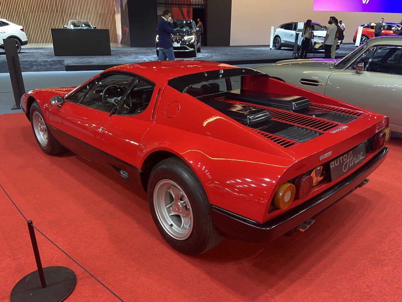 Red Ferrari 512 BB rear side with distinct rear lights and mid-engine design