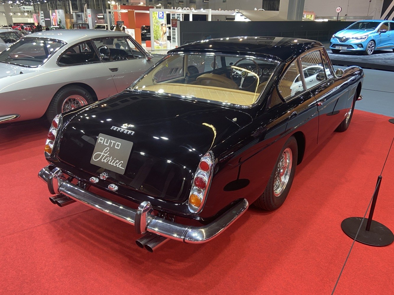 Rear view of classic 1960 grand tourer with dual exhaust and distinct tail lights