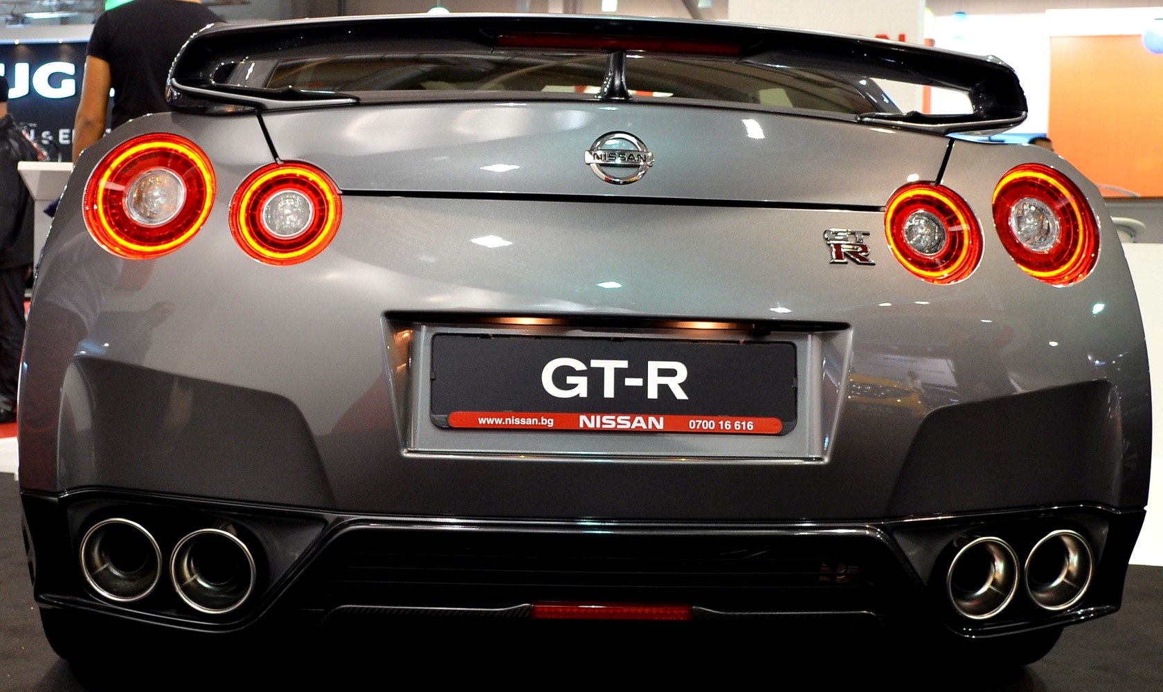 Quad exhaust tips and round rear taillights illuminated in rear view