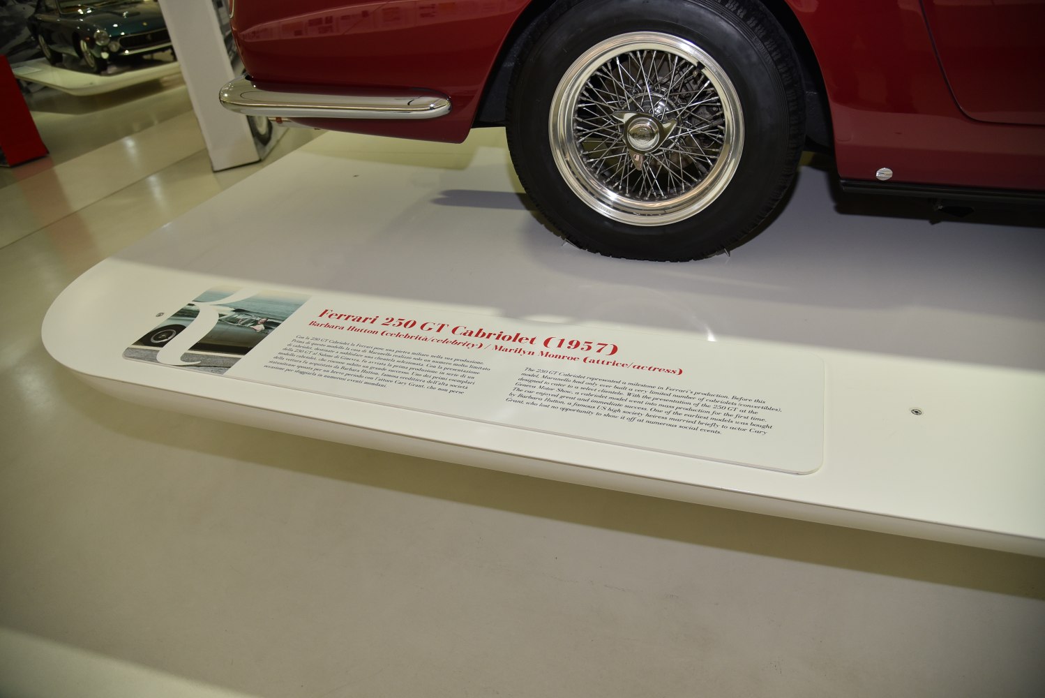 Wire-spoke wheel and chrome side skirt of a classic vintage vehicle.