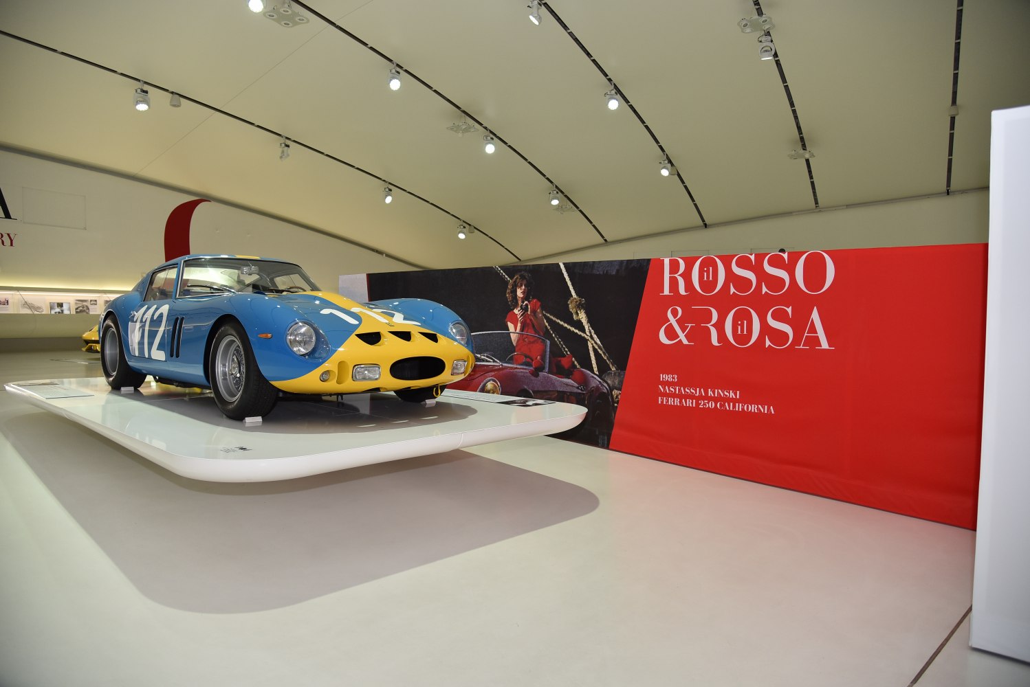1960s racing coupe with blue and yellow livery and aerodynamic vintage design
