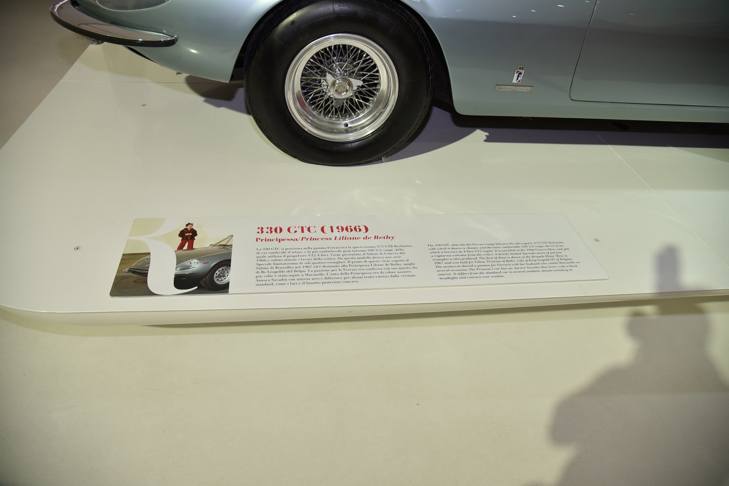 Wire-spoke wheel and side badge on vintage car