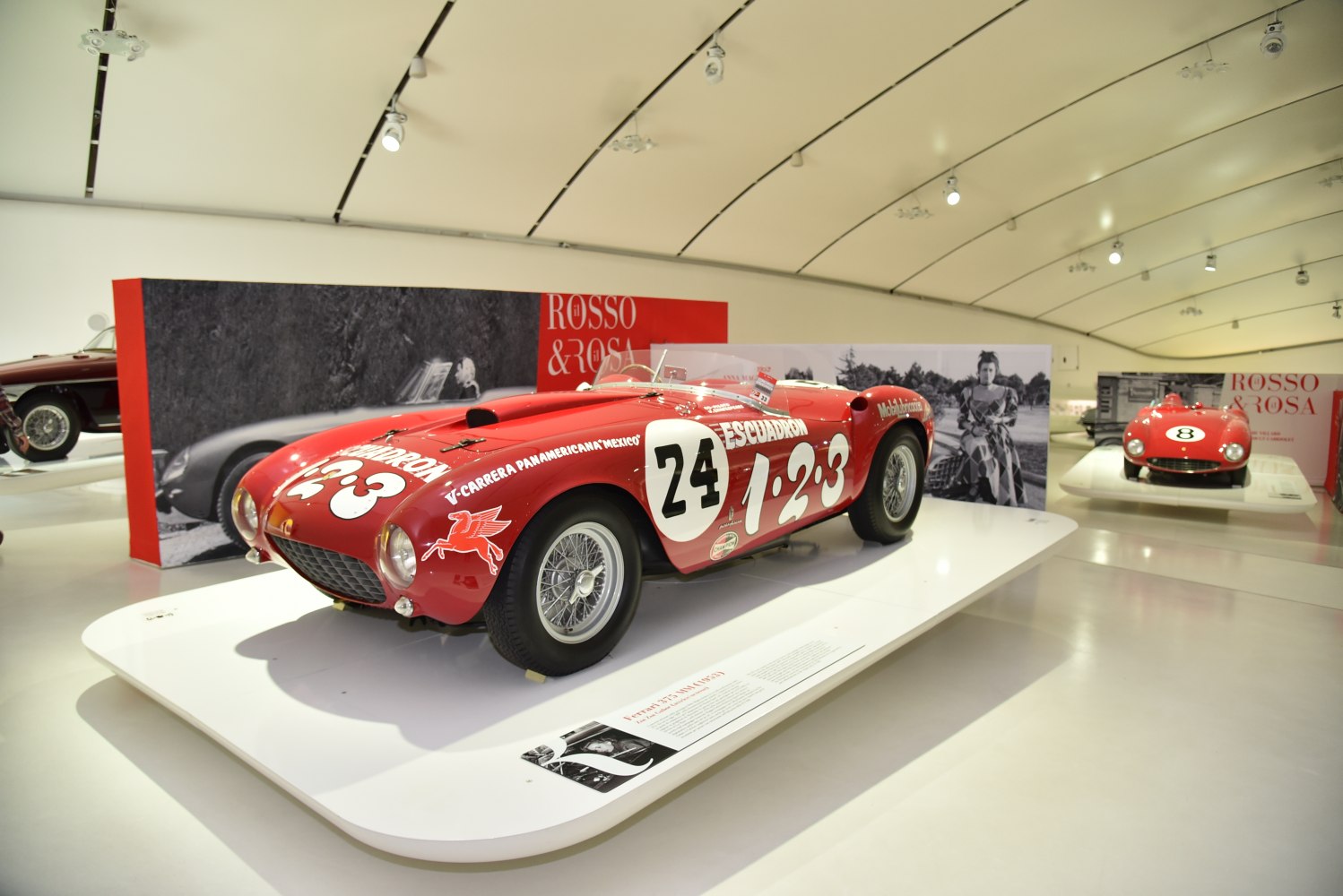 Red vintage racing roadster with wire wheels and numbered paint livery