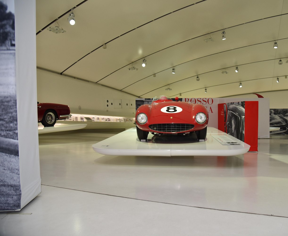 Front view of a vintage racing car with number 8 and round headlights