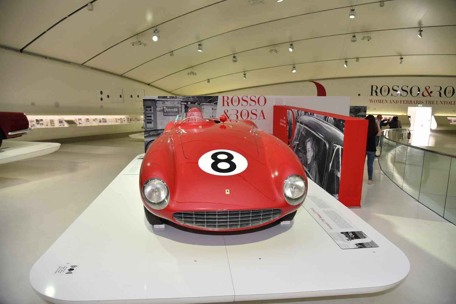 Front view of vintage racing car with number 8 on hood and iconic grille