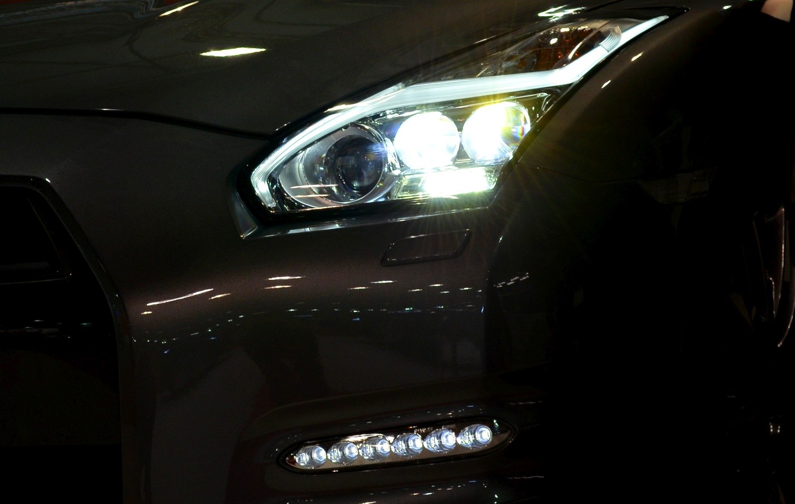 Close-up on sports car front headlight and LED fog lights
