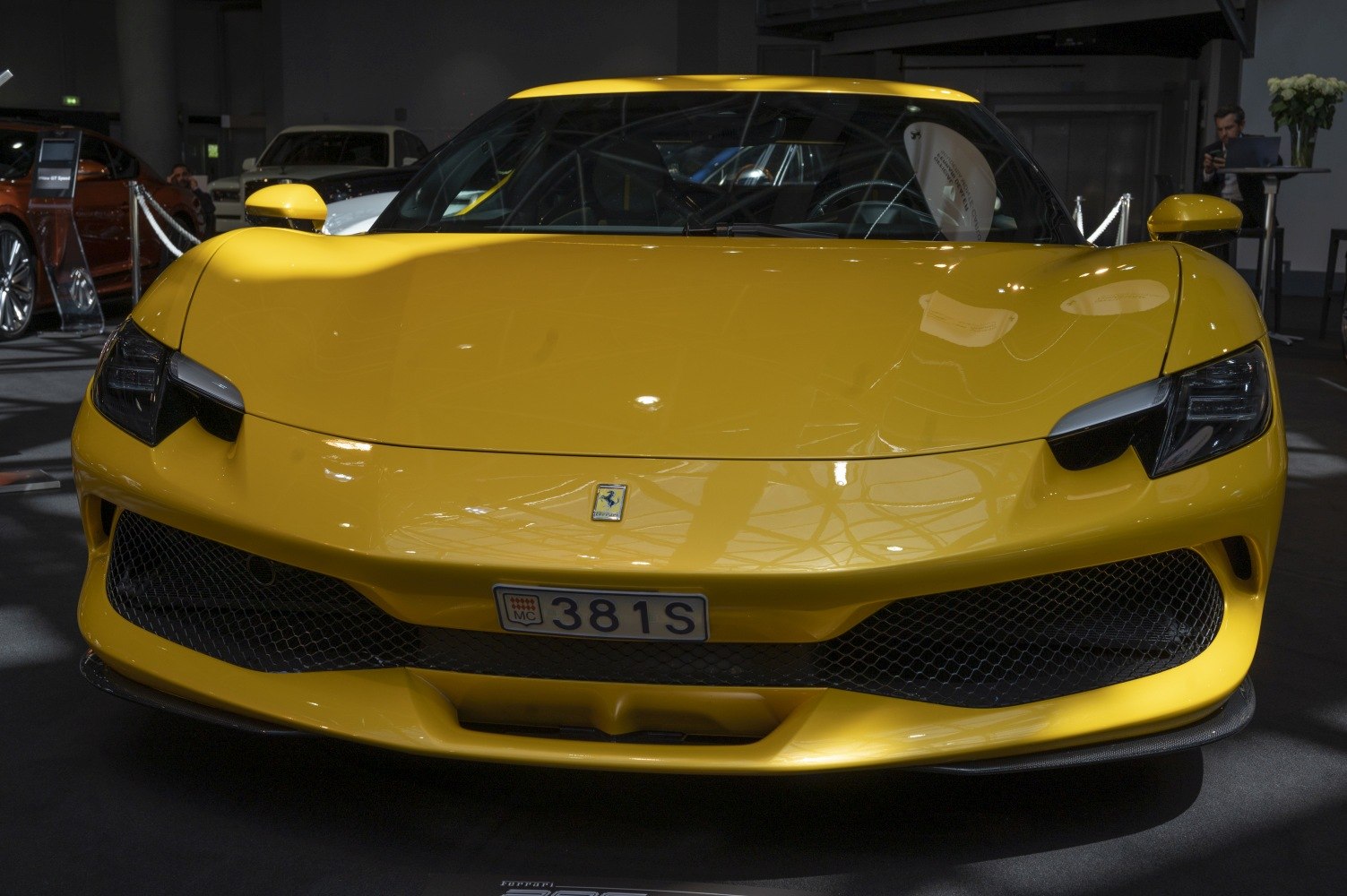 Yellow sports car front fascia with sleek headlights and grille
