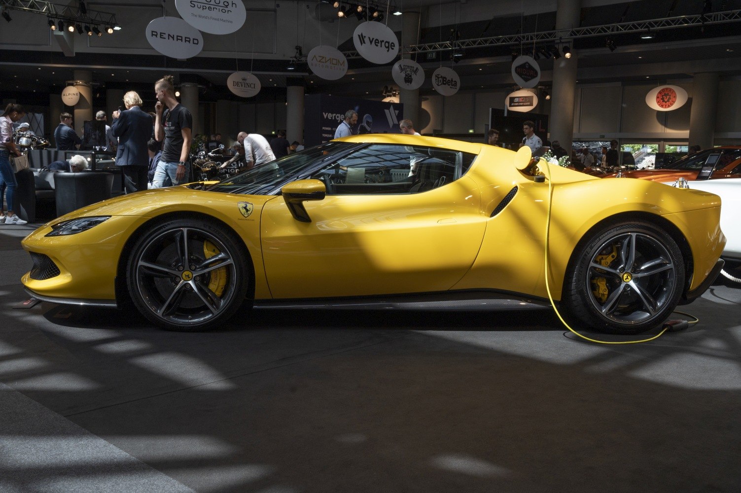 Yellow sports coupe with aerodynamic shape and charging cable