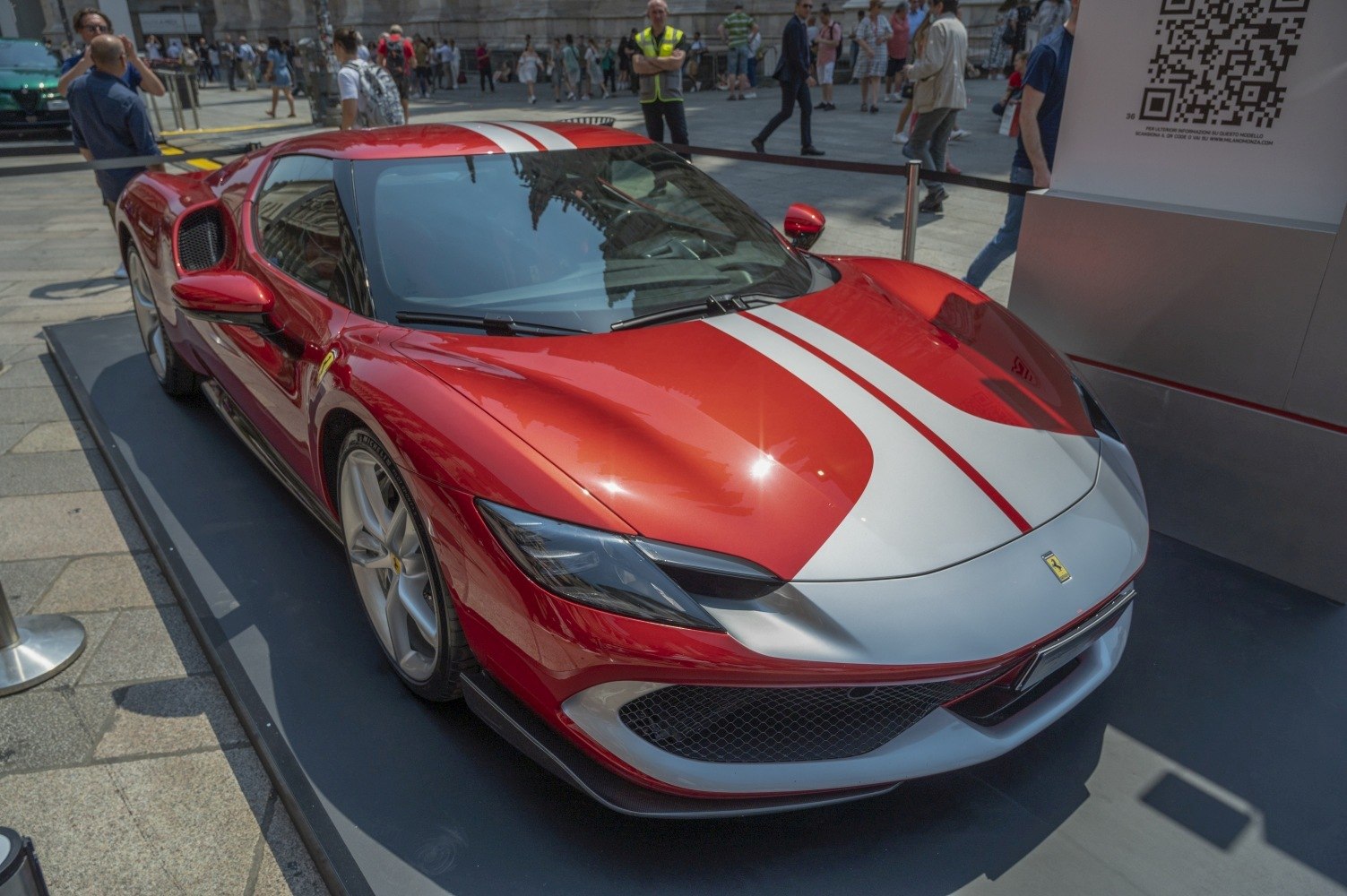 Red sports car front with white racing stripe