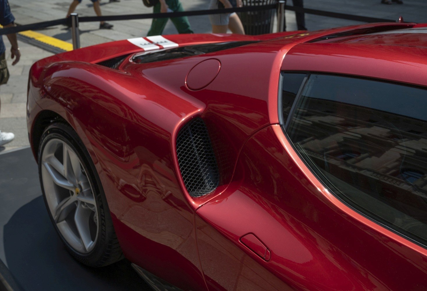Rear quarter panel with side air intake vent and wheel rim.