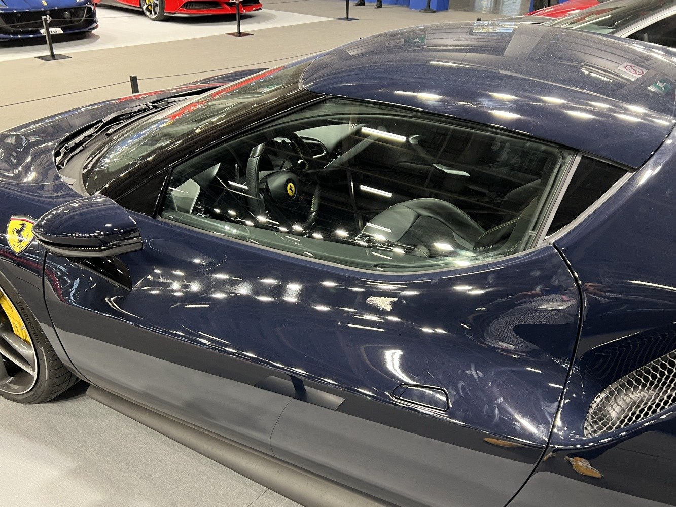 Sleek sports coupe door and interior view with aerodynamic side mirror
