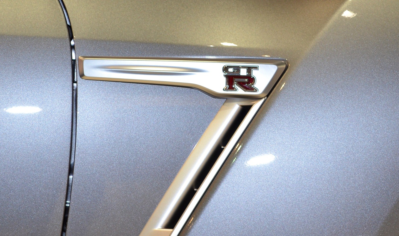 Close-up of Nissan GT-R R35 facelift emblem and side vent