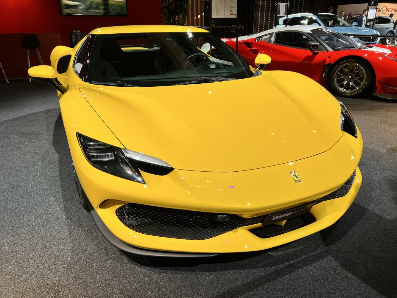 Front end of yellow sports coupe with LED headlights and large air intakes