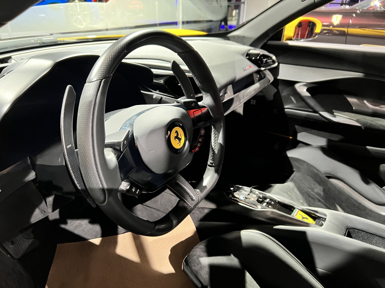 Carbon fiber steering wheel with paddle shifters and minimalist modern sports car interior