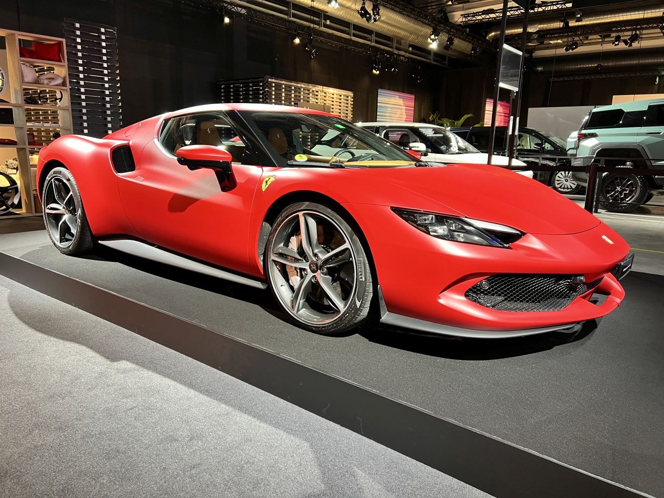 Red matte sports coupe with aerodynamic styling and alloy wheels