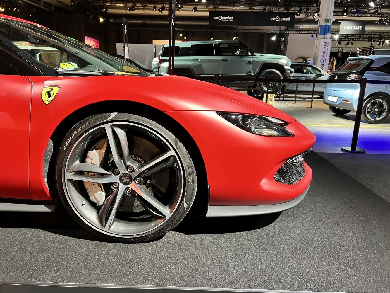 Close-up of sports car front wheel, brake, and headlight