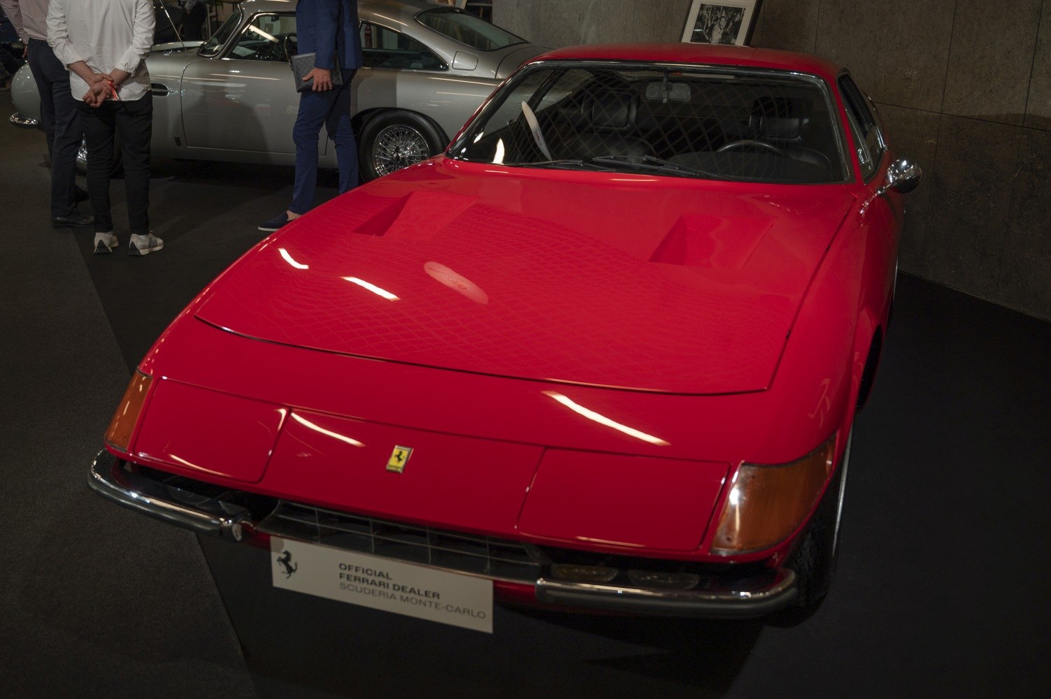 Front view of red classic sports car with iconic hood and headlights