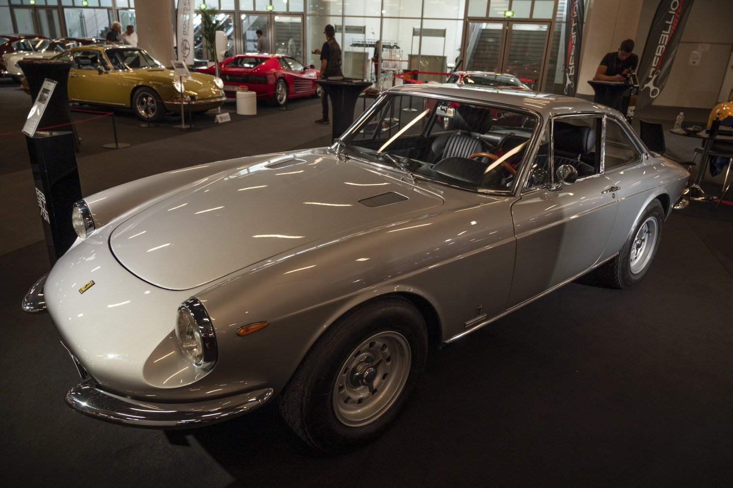 Front view of vintage coupe with round headlights and streamlined body.