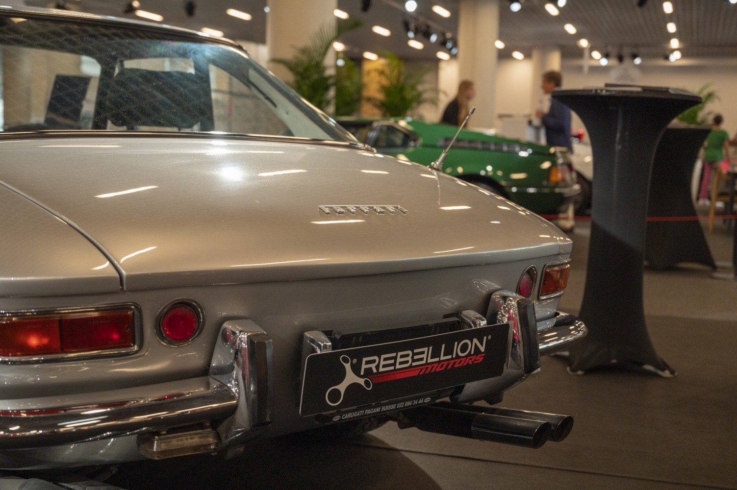 Rear view of classic car with round taillights and chrome bumper