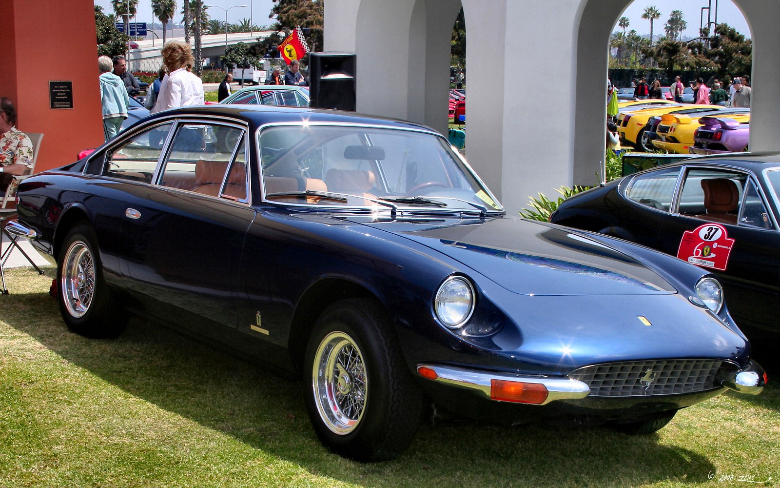 Luxury coupe with wire spoke wheels and chrome bumper