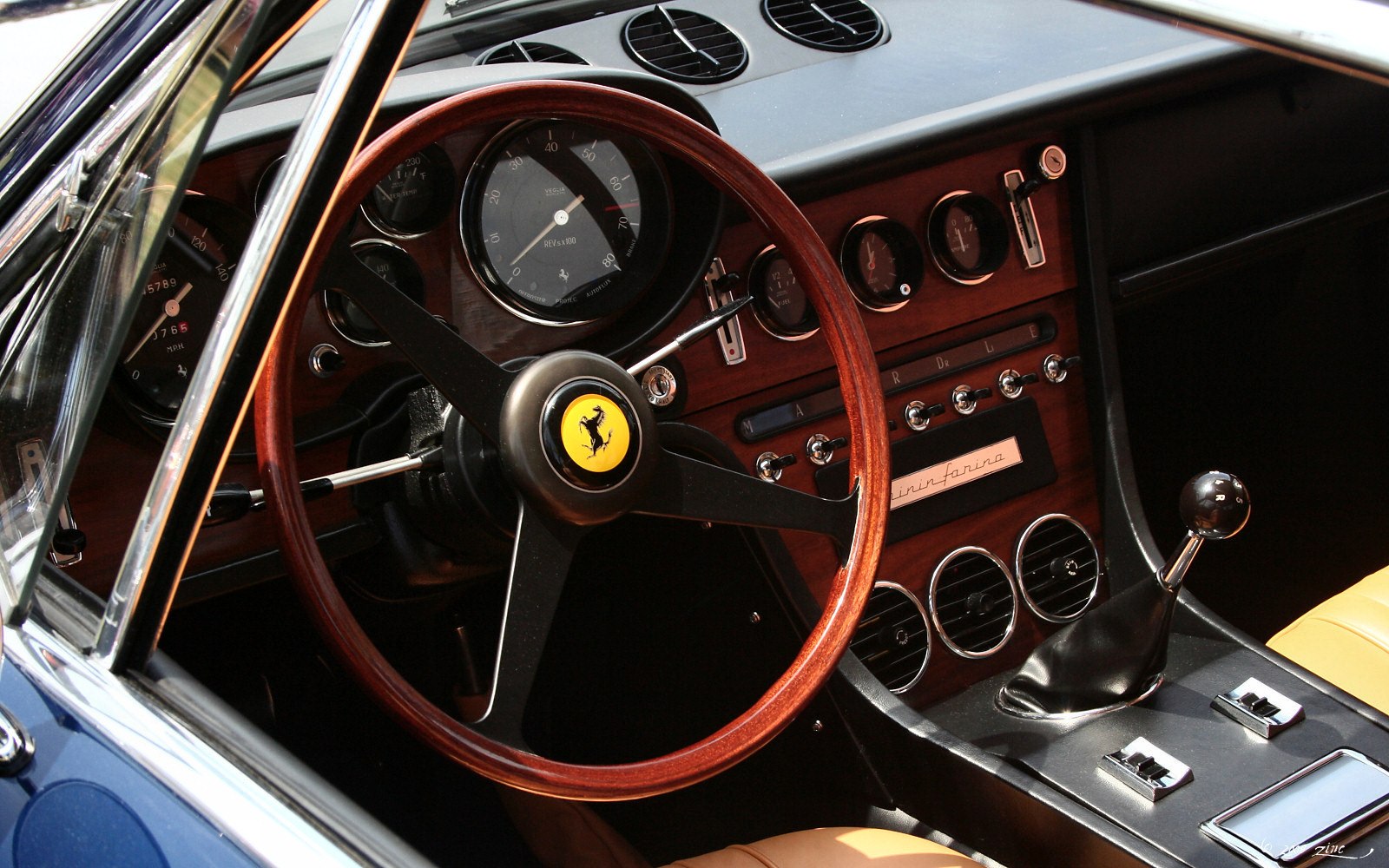 Classic wooden steering wheel and vintage dashboard cluster
