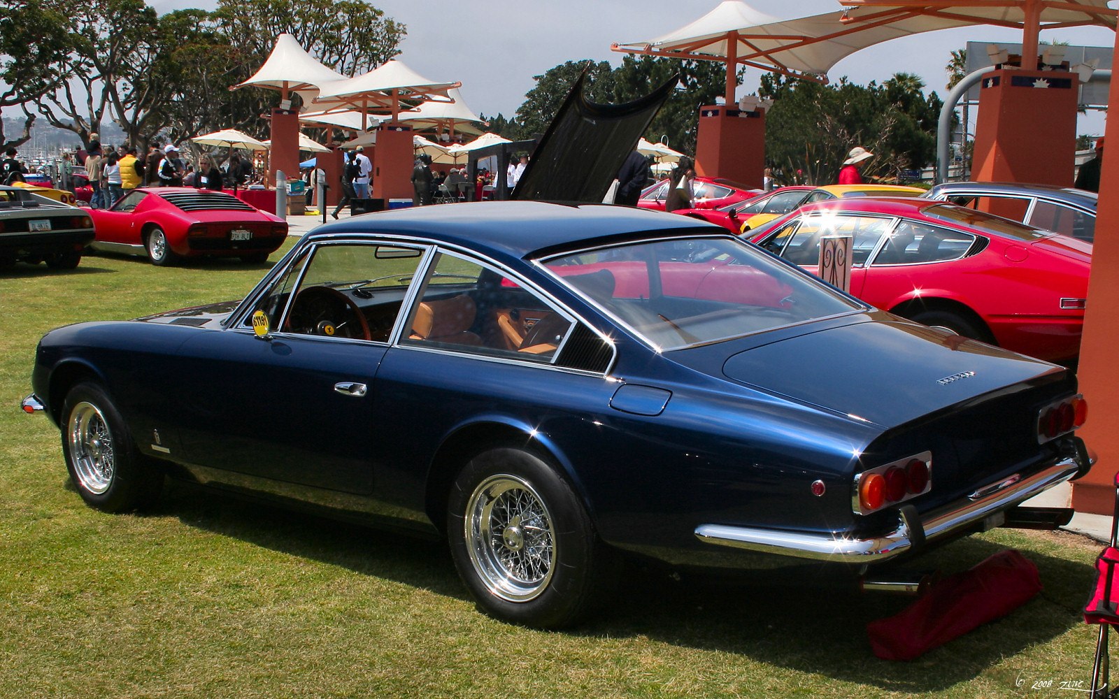 Sleek vintage coupe with wire-spoke wheels and a fastback rear design.