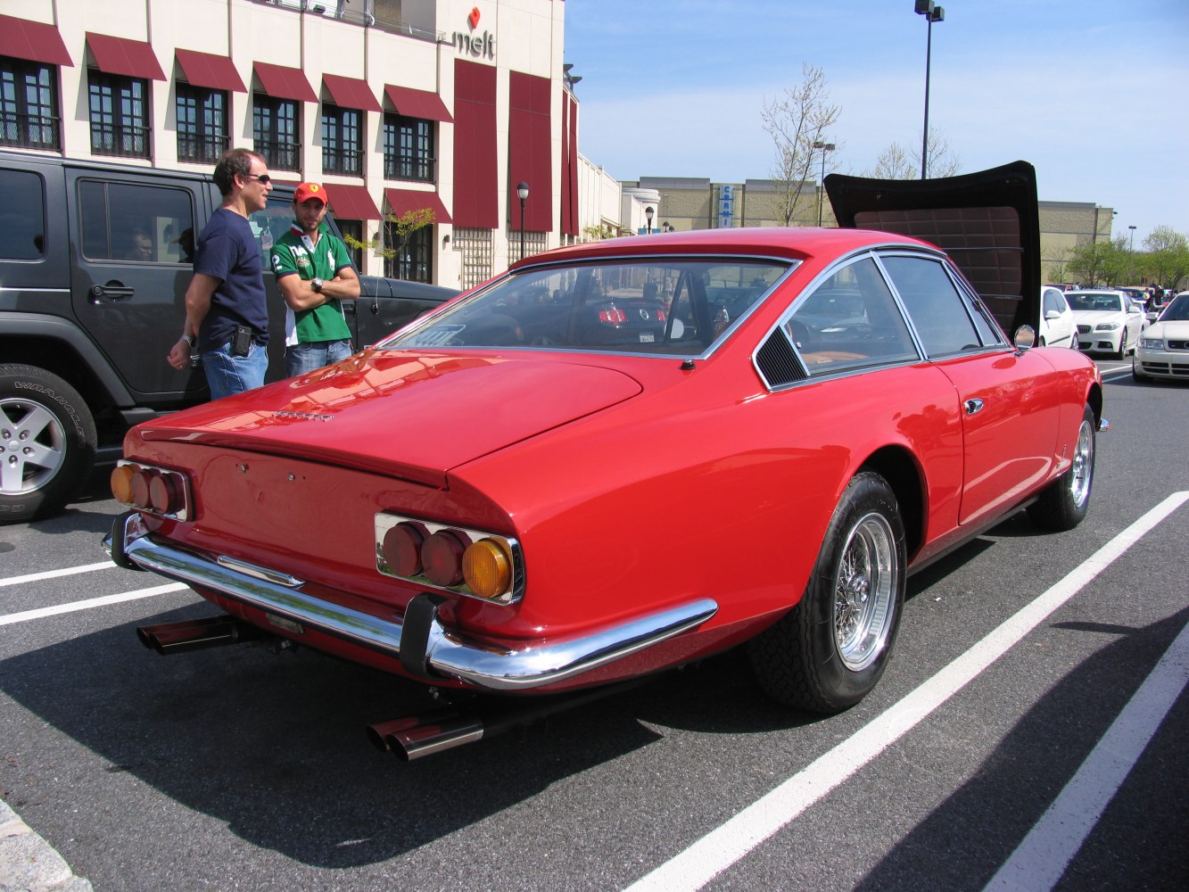 Rear view of classic fastback coupe with chrome bumper and dual exhaust.