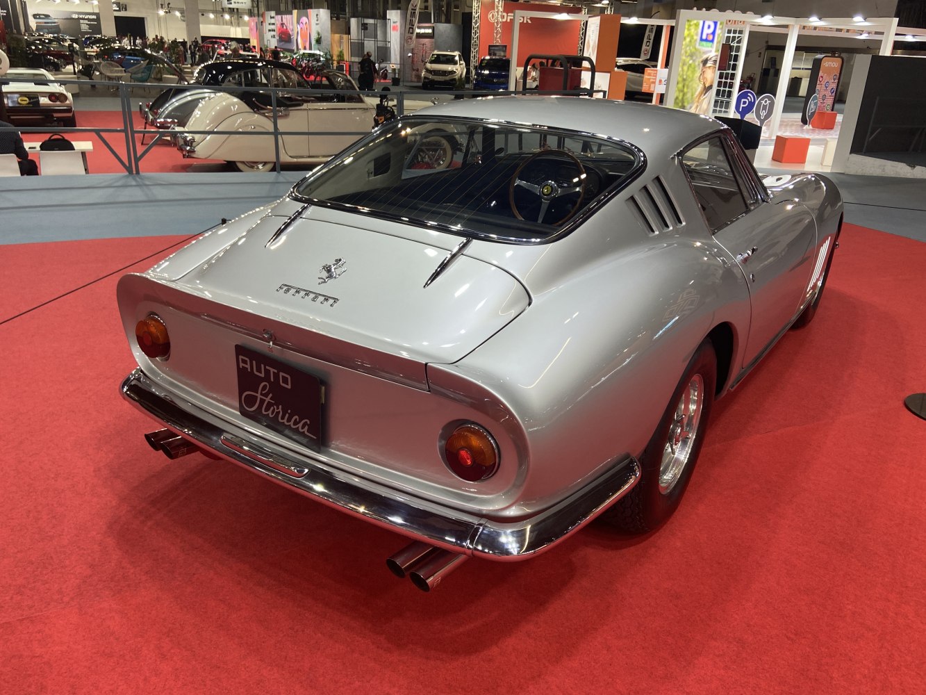 Vintage coupe rear view with dual exhaust, round tail lights, and smooth rear window.
