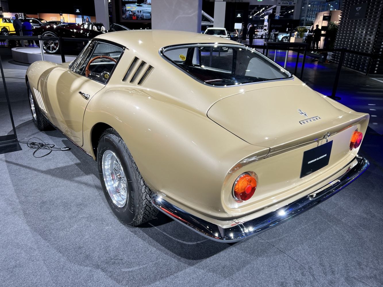 Curved rear with triple side vents and chrome bumper on classic coupe