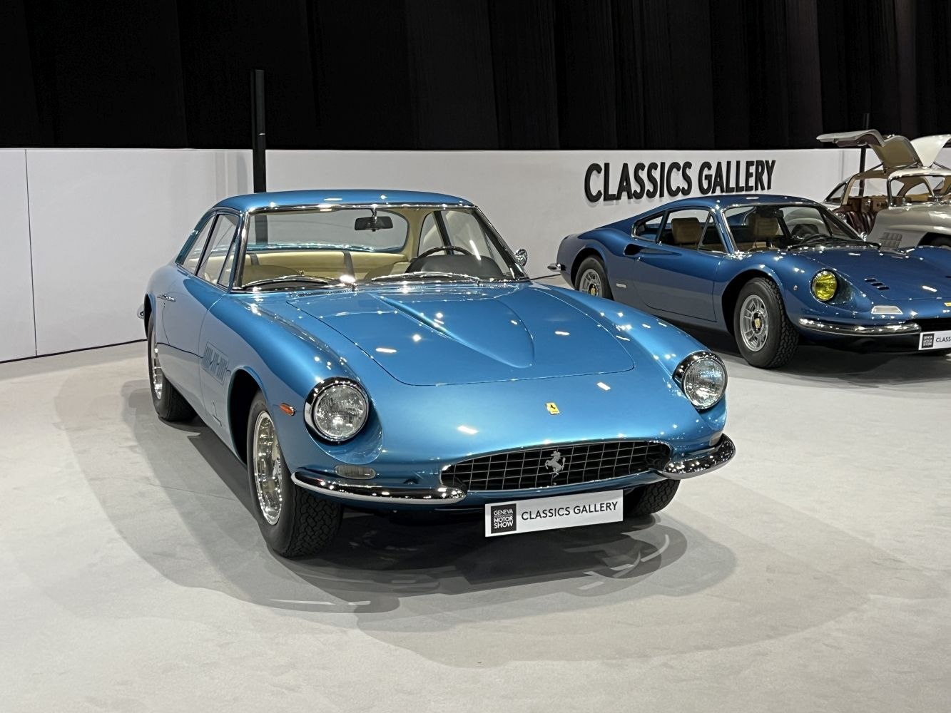 Blue vintage coupe with rounded headlights and chrome bumper