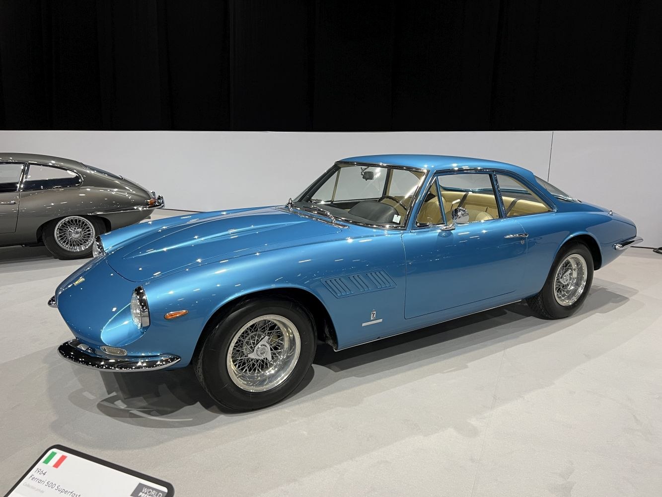 Classic blue luxury sports coupe with wire-spoke wheels