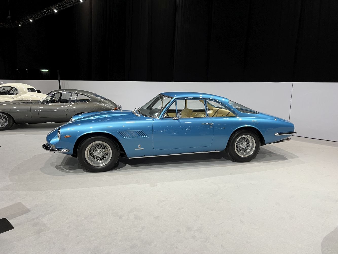 1960s vintage blue sports coupe with wire wheels and aerodynamic profile