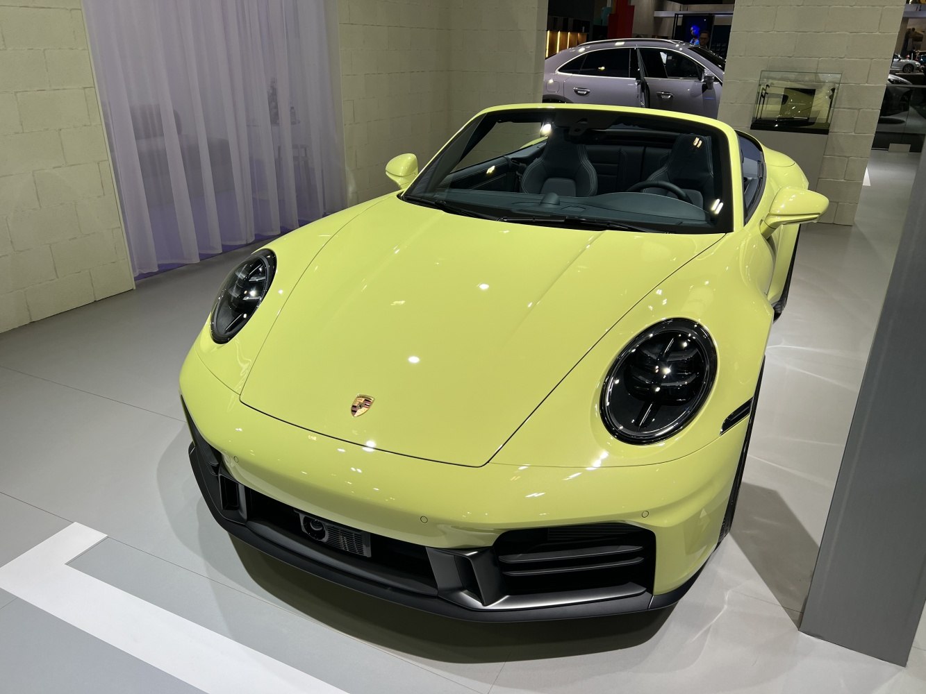 Yellow convertible sports car front with round headlights