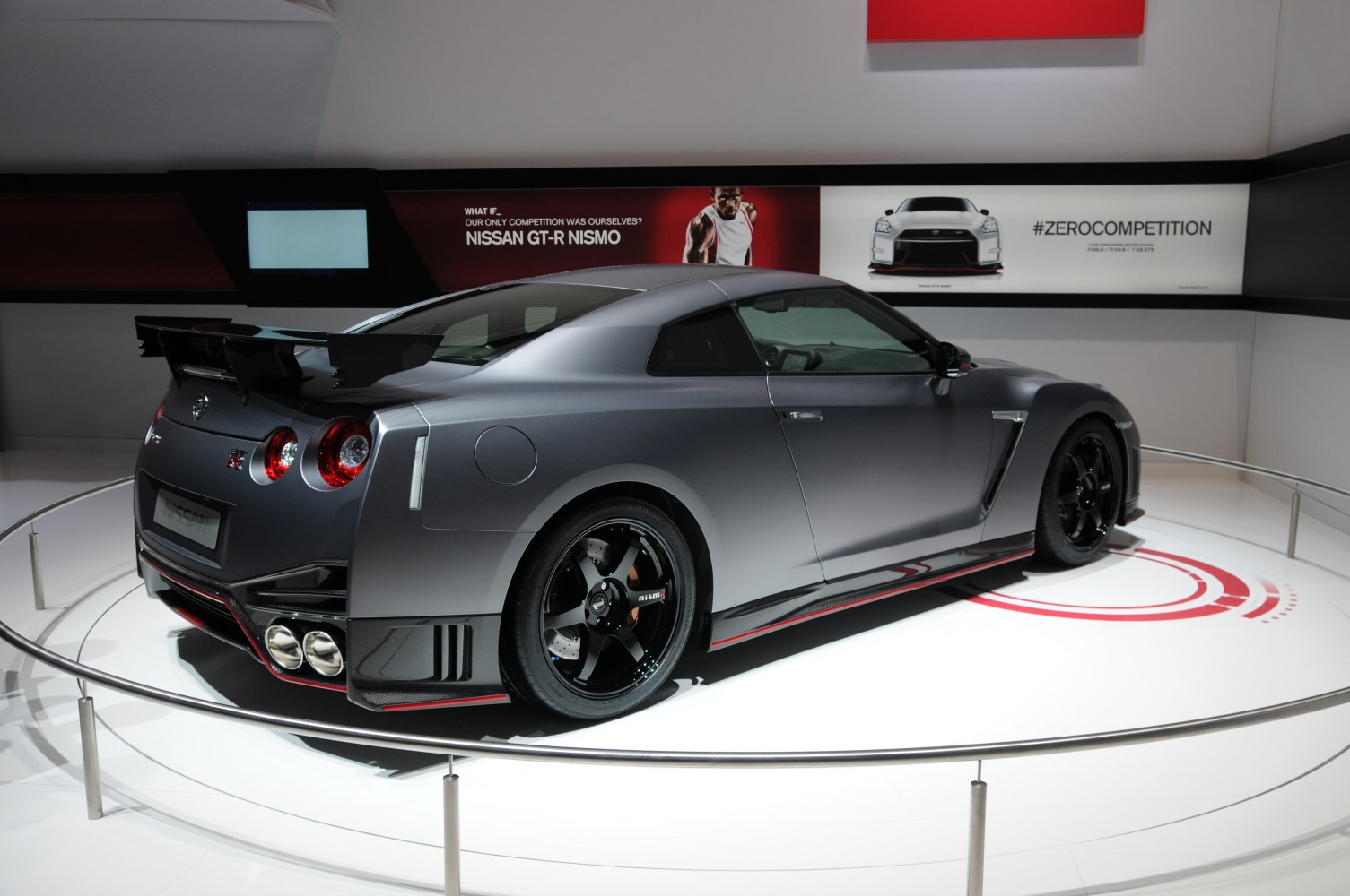 Rear view of sports coupe with large spoiler and quad exhaust
