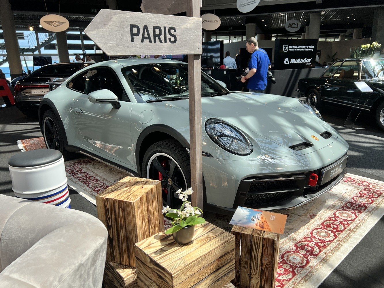 Front and side view of a sporty off-road styled coupe on display carpet.