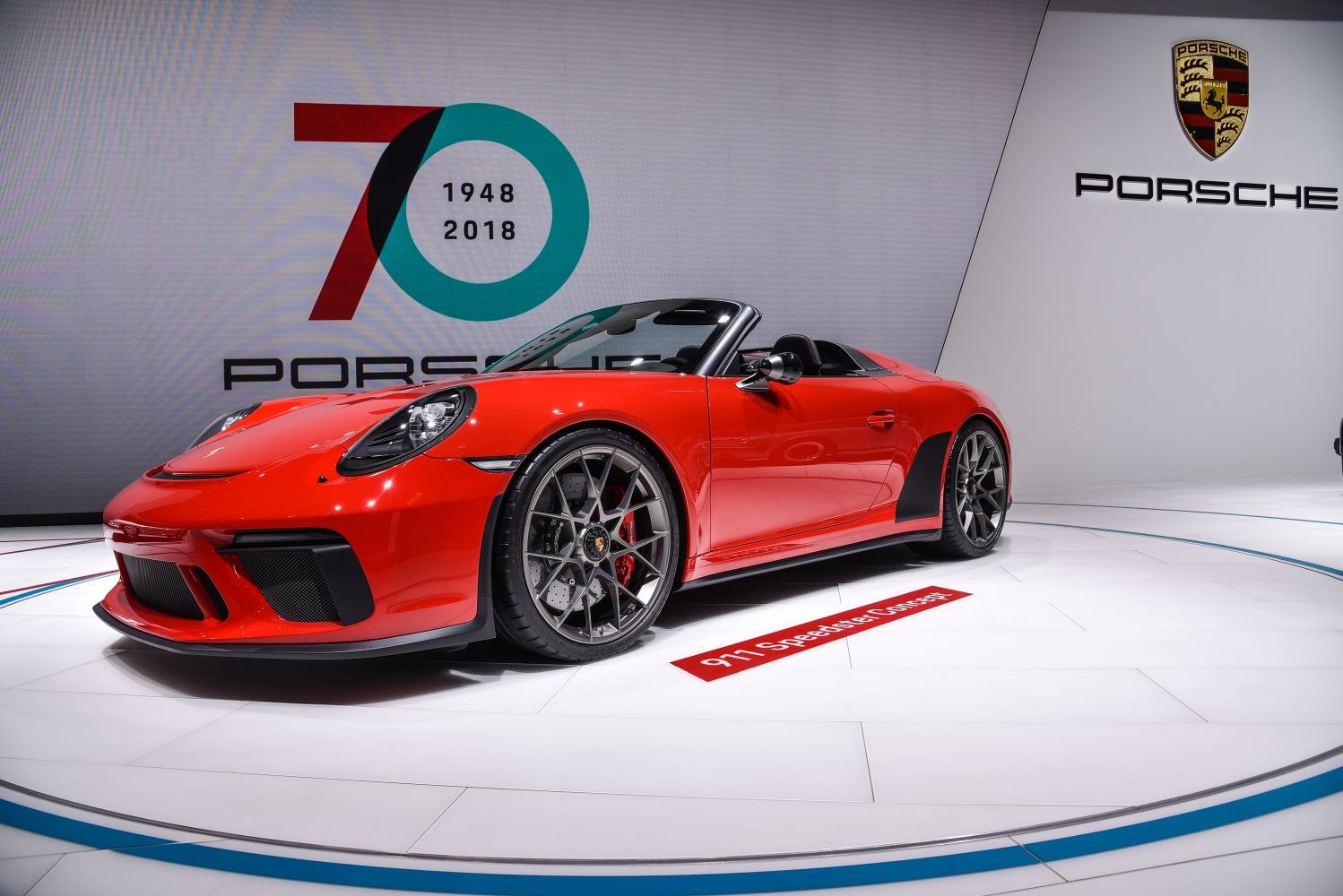 Red convertible with prominent rear arches and multi-spoke alloy wheels