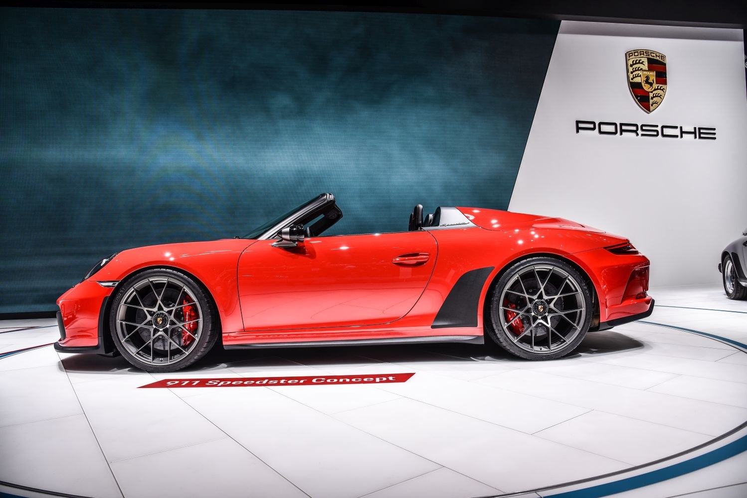 Red convertible sports car with sporty wheels and aerodynamic design