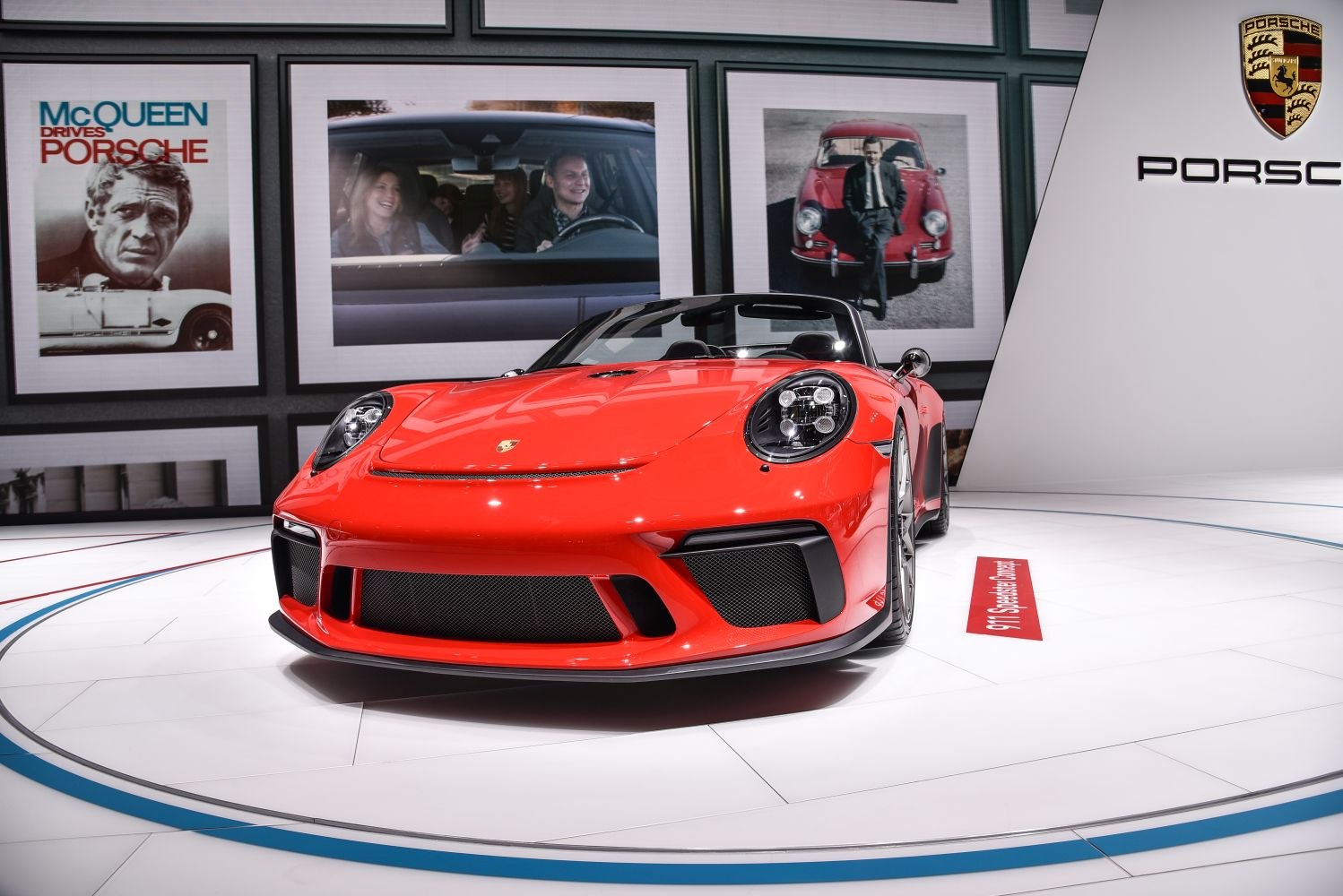 Red convertible sports car with round LED headlights and large front intakes