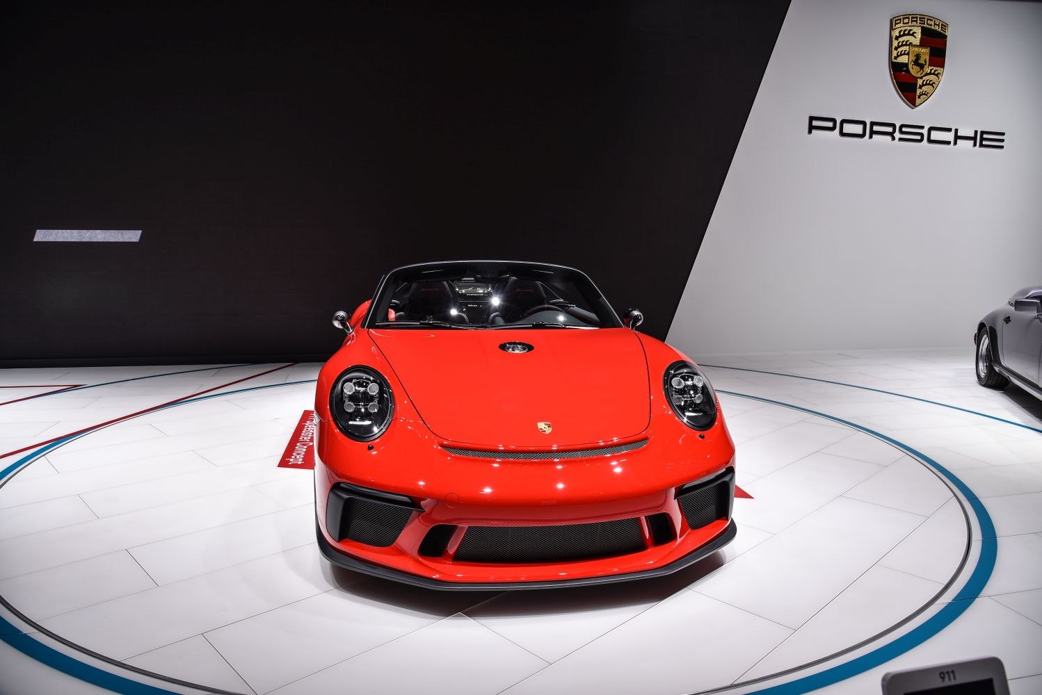 Red Porsche 911 Speedster front with iconic headlights and sporty grille