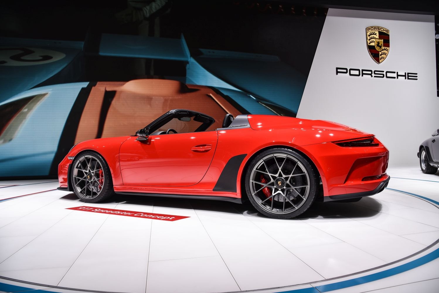 Red convertible sports car with black alloy wheels side view