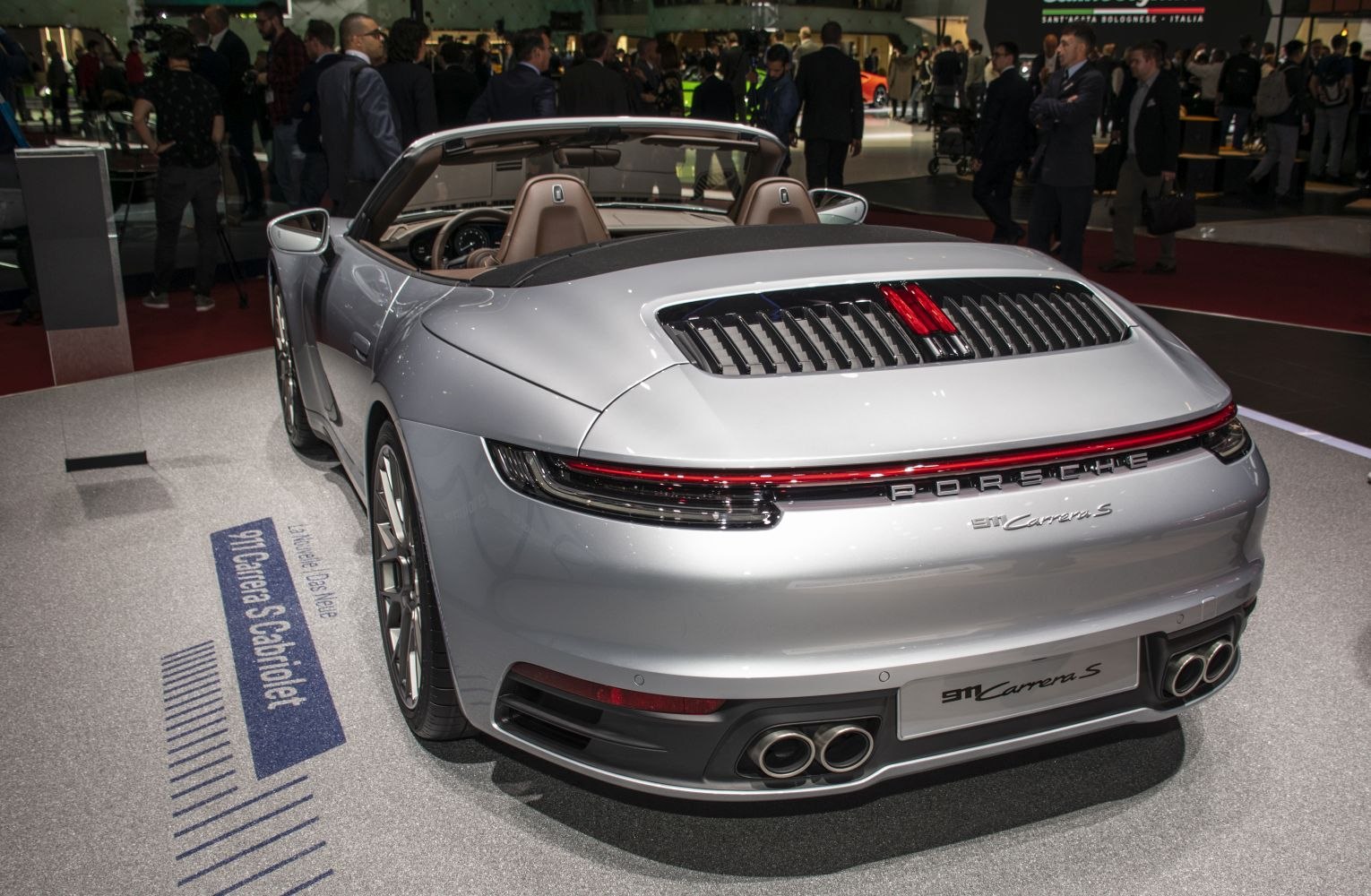 Rear view of convertible sports vehicle with quad exhaust and horizontal tail light strip