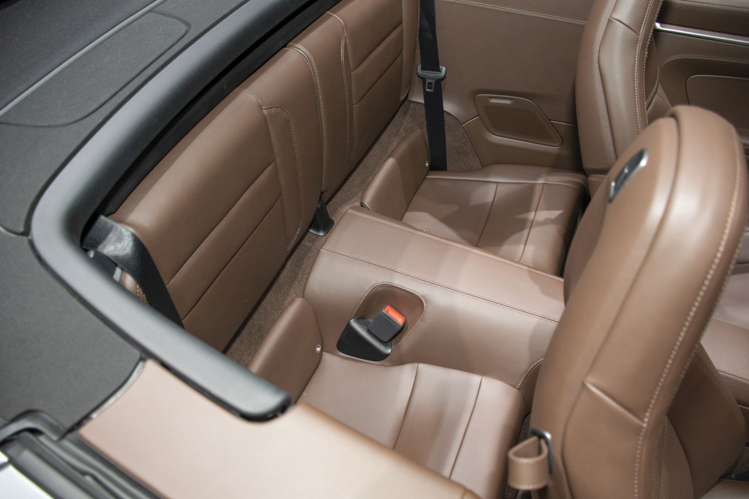Rear brown leather seats with seat belts in luxury sports convertible