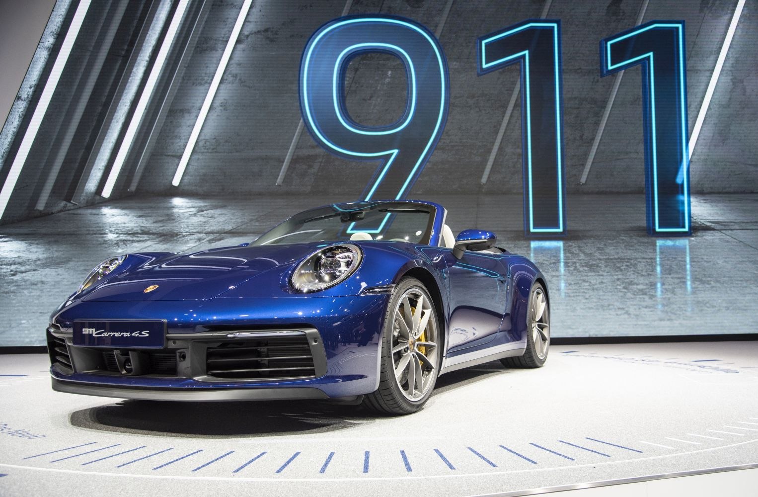 Blue convertible sports car with aerodynamic front and LED headlights